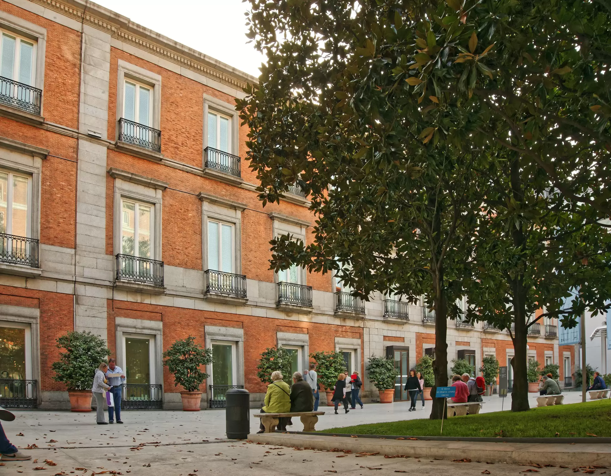 Couple sitting outside the Thyssen-Bornemisza Museum in Madrid, Spain.