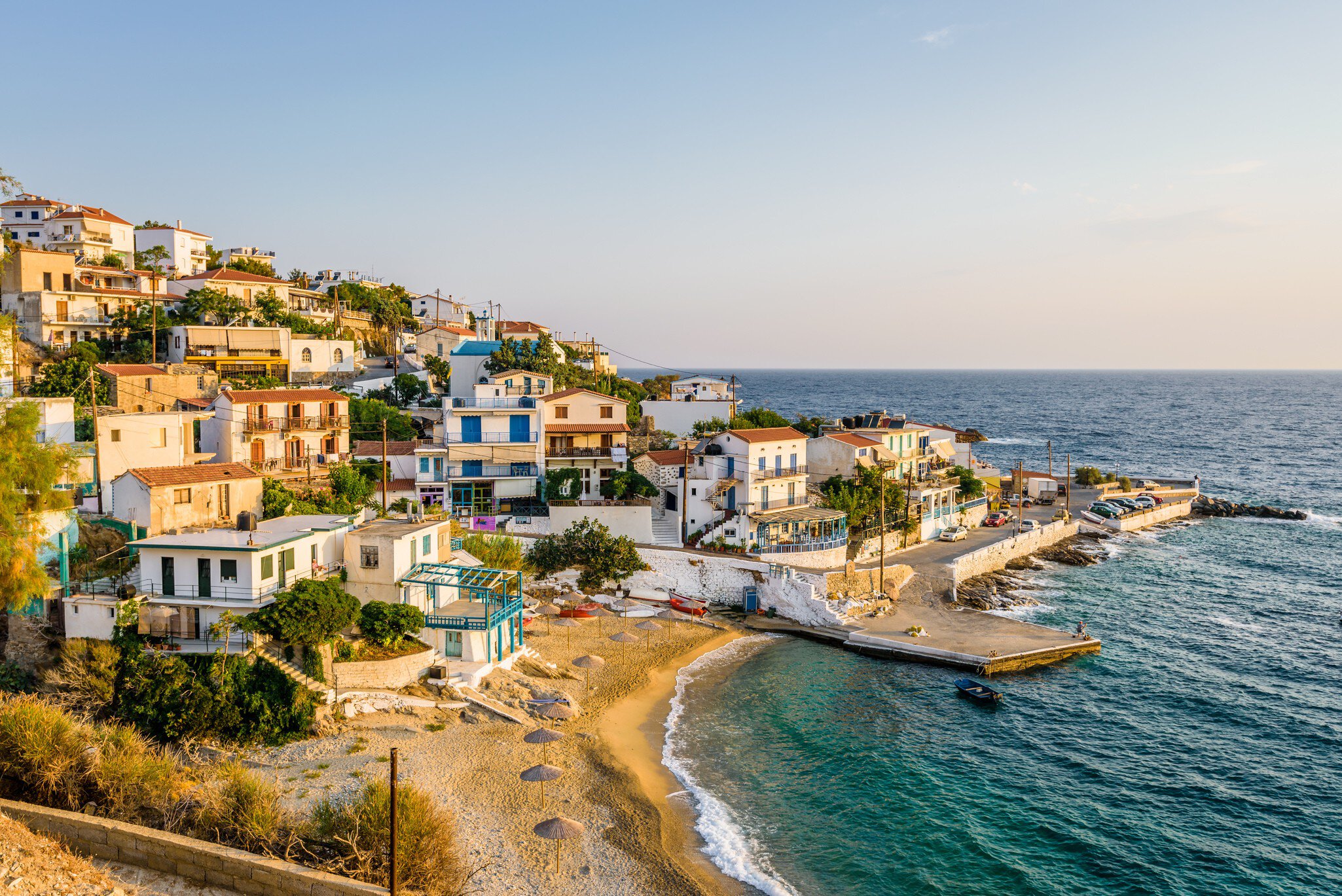 The late afternoon sun shines on the coastal village of Armenistis on the island of Ikaria in Greece.