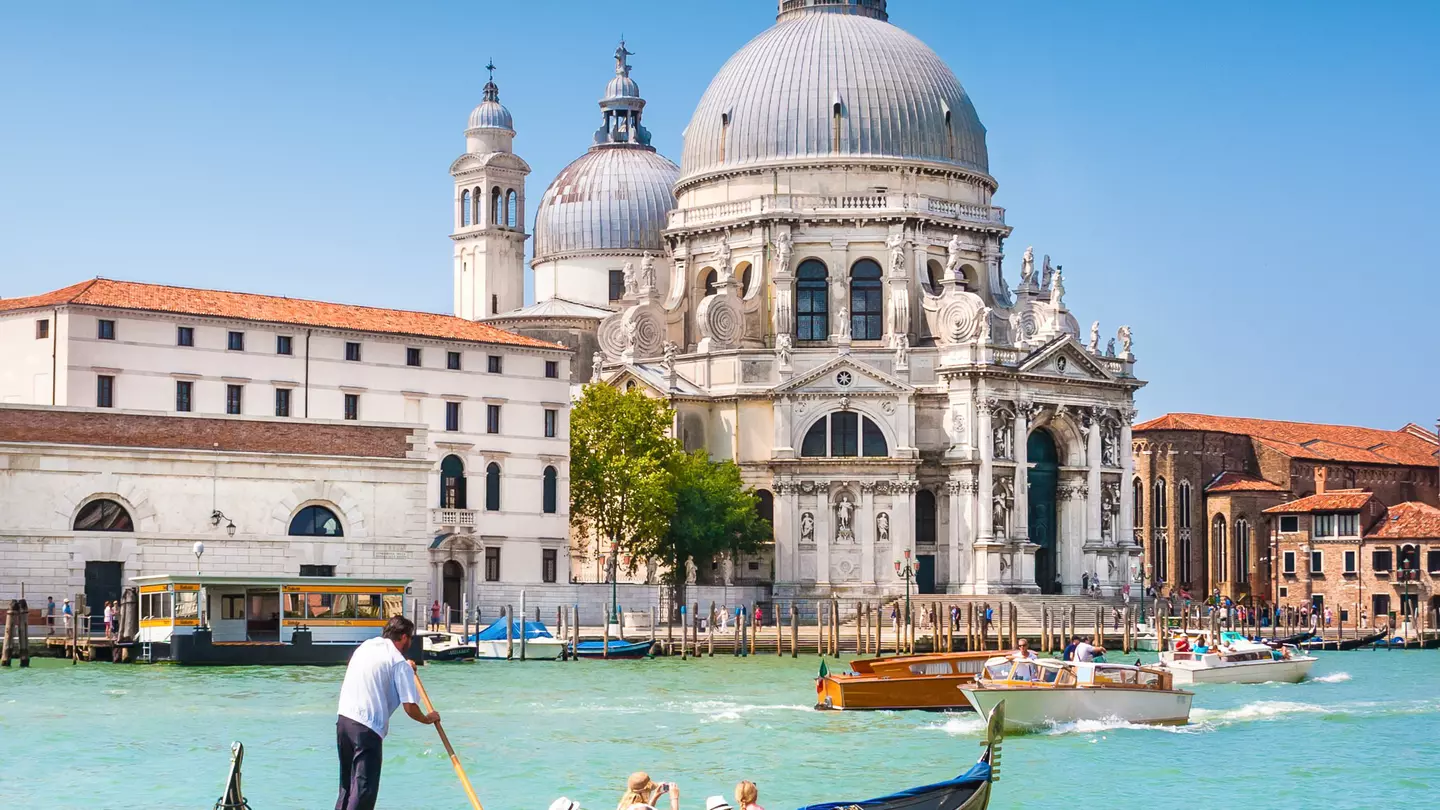 Traditional Gondola on the Canal Grande with Basilica di Santa Maria della Salute in the background in Venice, Italy