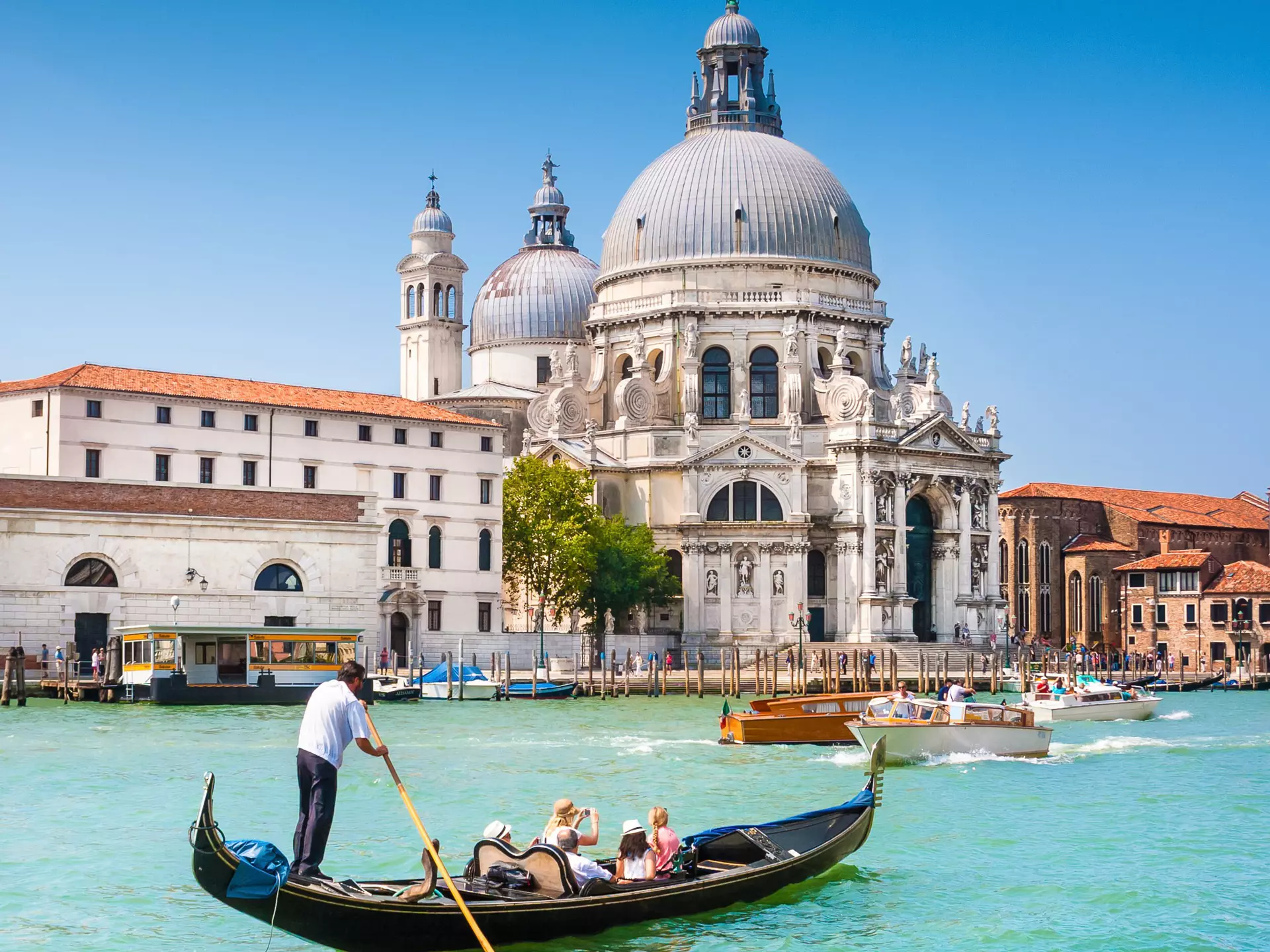 Traditional Gondola on the Canal Grande with Basilica di Santa Maria della Salute in the background in Venice, Italy