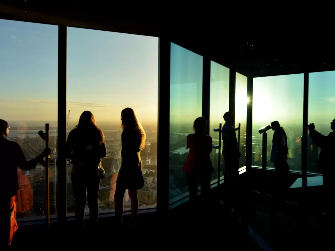 Silhouettes of visitors at Eureka Tower observation deck (Eureka Skydeck 88), the highest public vantage point in a building in the Southern Hemisphere. Melbourne, Australia. 