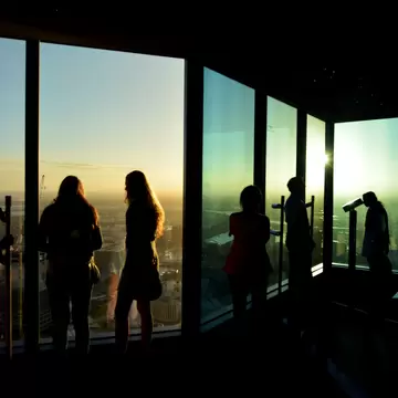 Silhouettes of visitors at Eureka Tower observation deck (Eureka Skydeck 88), the highest public vantage point in a building in the Southern Hemisphere. Melbourne, Australia. 