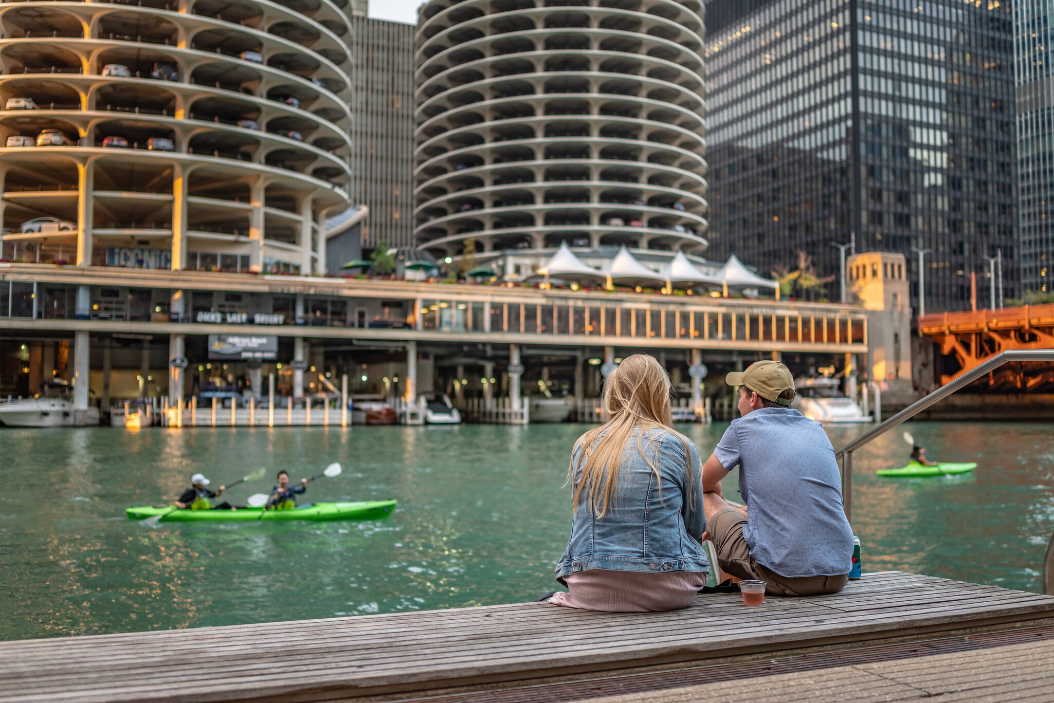 Friends hanging out along the Riverwalk by the Chicago River in Chicago, Illinois.