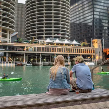 Friends hanging out along the Riverwalk by the Chicago River in Chicago, Illinois.