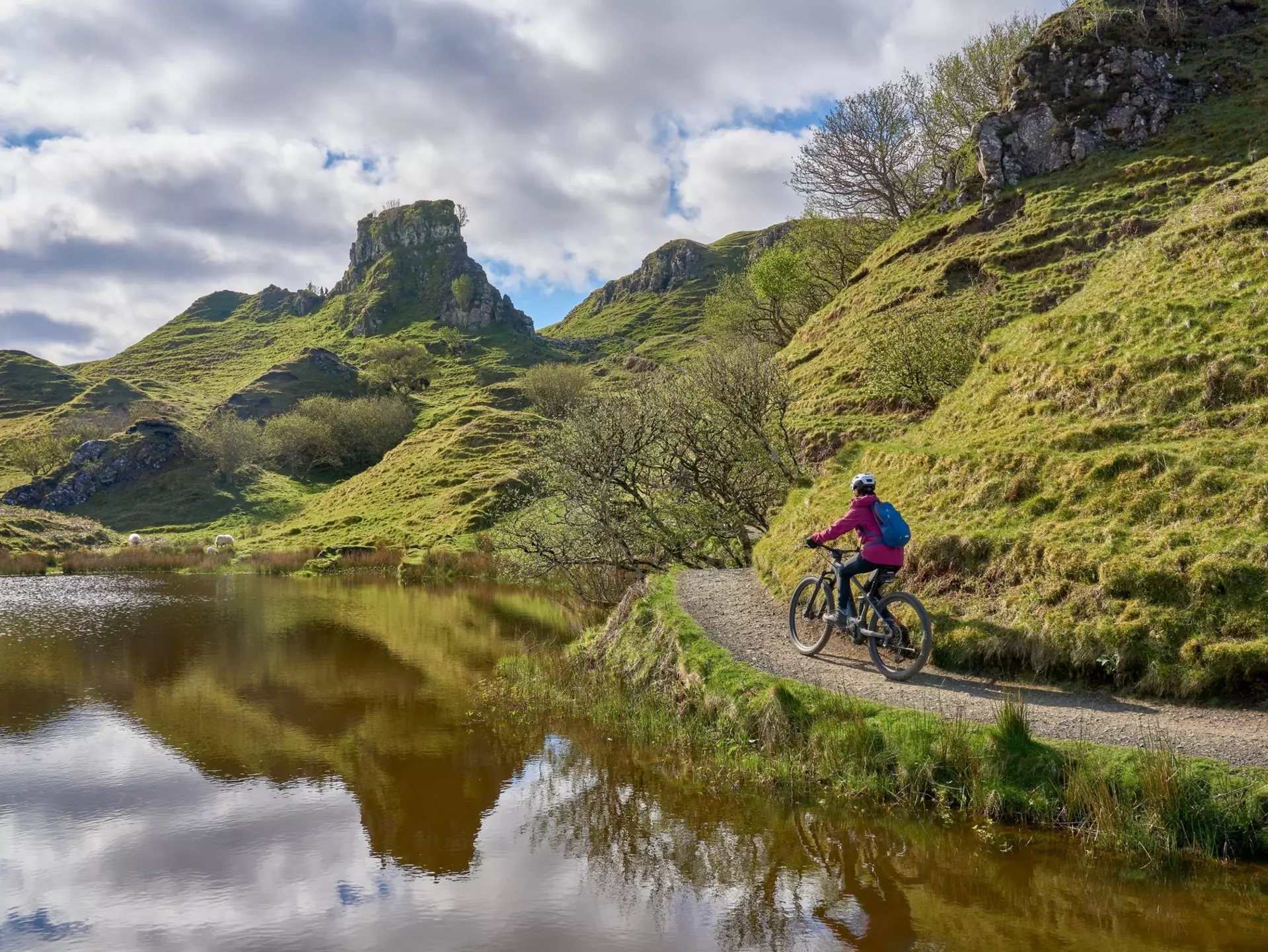 active woman riding her electric mountain bike in the spectacular volcabinic landscape of Glen Fairy on the Isle of Skye in Scotland, UK, License Type: media, Download Time: 2025-10-29T13:57:23.000Z, User: katelyn.perry_lonelyplanet, Editorial: false, purchase_order: 65050 - Digital Destinations and Articles, job: wip, client: wip, other: Katelyn Perry