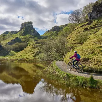 active woman riding her electric mountain bike in the spectacular volcabinic landscape of Glen Fairy on the Isle of Skye in Scotland, UK, License Type: media, Download Time: 2025-10-29T13:57:23.000Z, User: katelyn.perry_lonelyplanet, Editorial: false, purchase_order: 65050 - Digital Destinations and Articles, job: wip, client: wip, other: Katelyn Perry