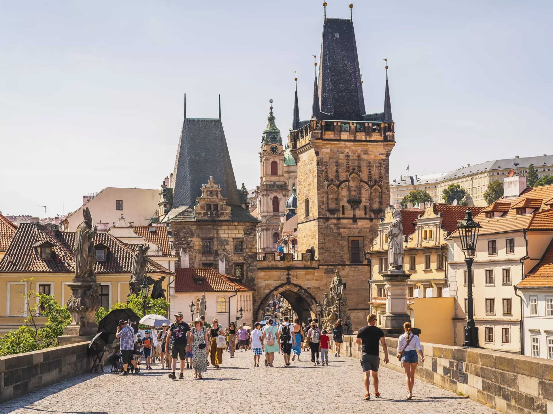 People crossing Charles Bridge in Prague, Czechia