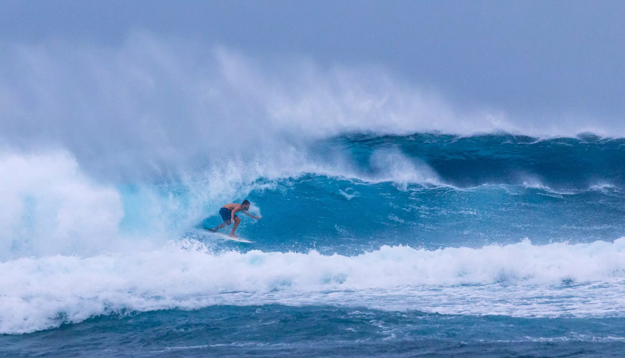 A surfer on a big wave at Siargao, Philippines.