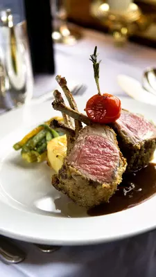 A lamb dish served in a train dining car.