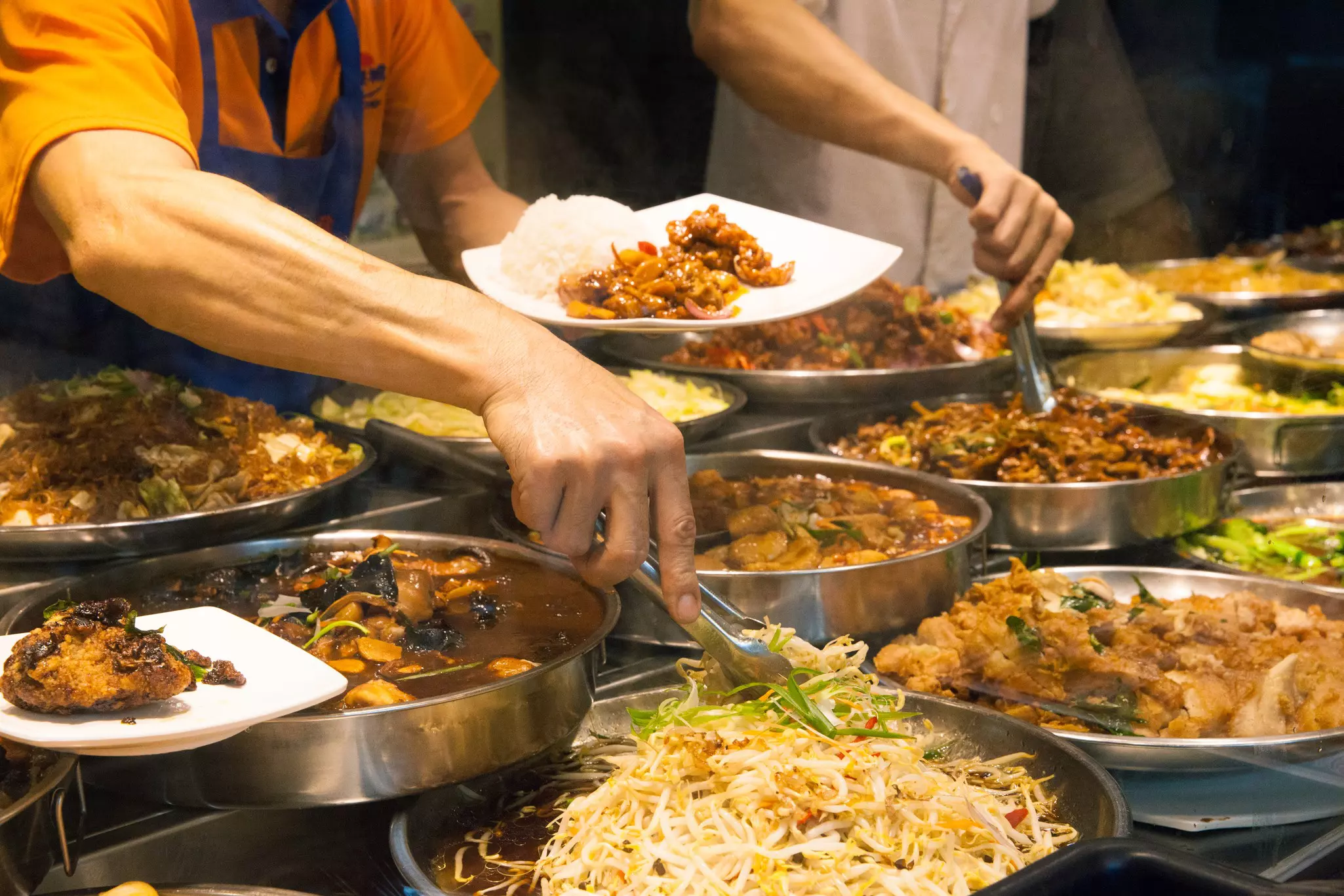 Eat like a local at one of Singapore's open-air hawker centers © Elena Aleksandrovna Ermakova / Getty Images