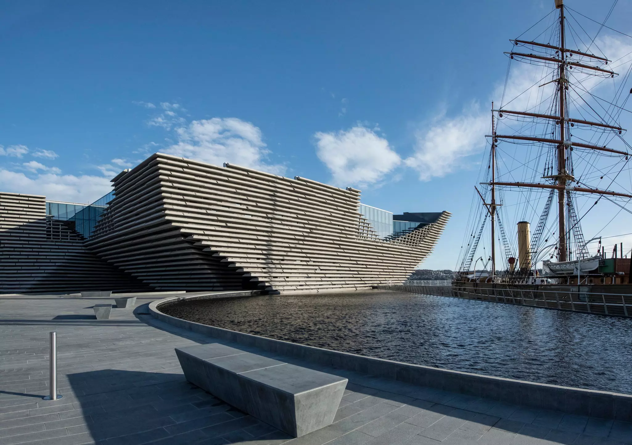 A museum building in Dundee, Scotland, that echoes the shape of a sailing vessel docked in the harbor.