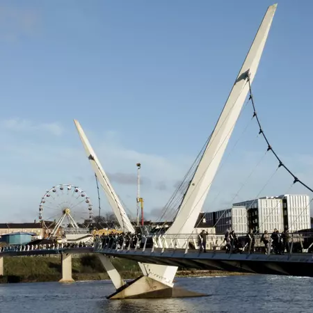 A suspension bridge with two white arms.