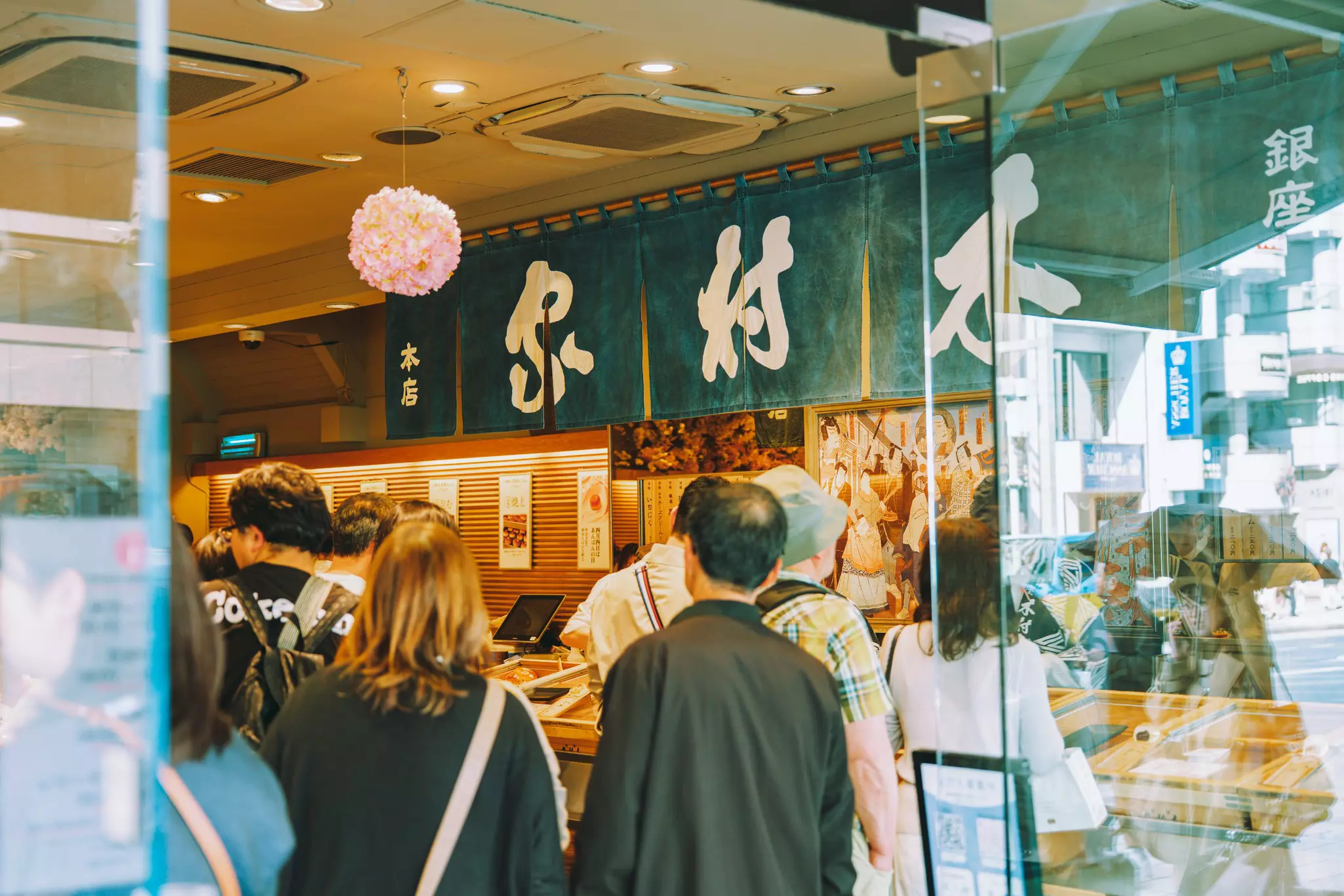People waiting at the entrance to a restaurant