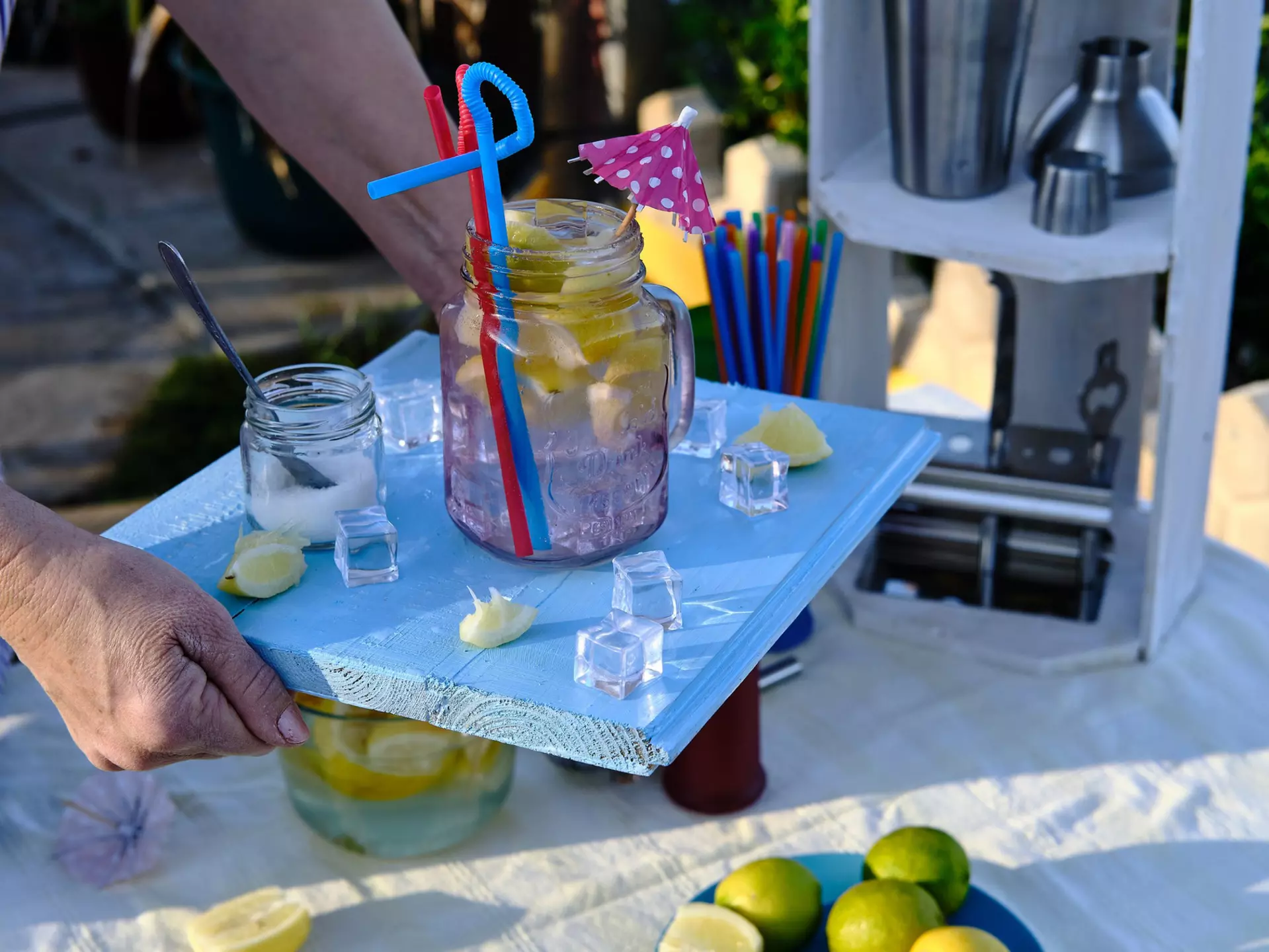 Waitress brings a cocktail on her blue wooden tray