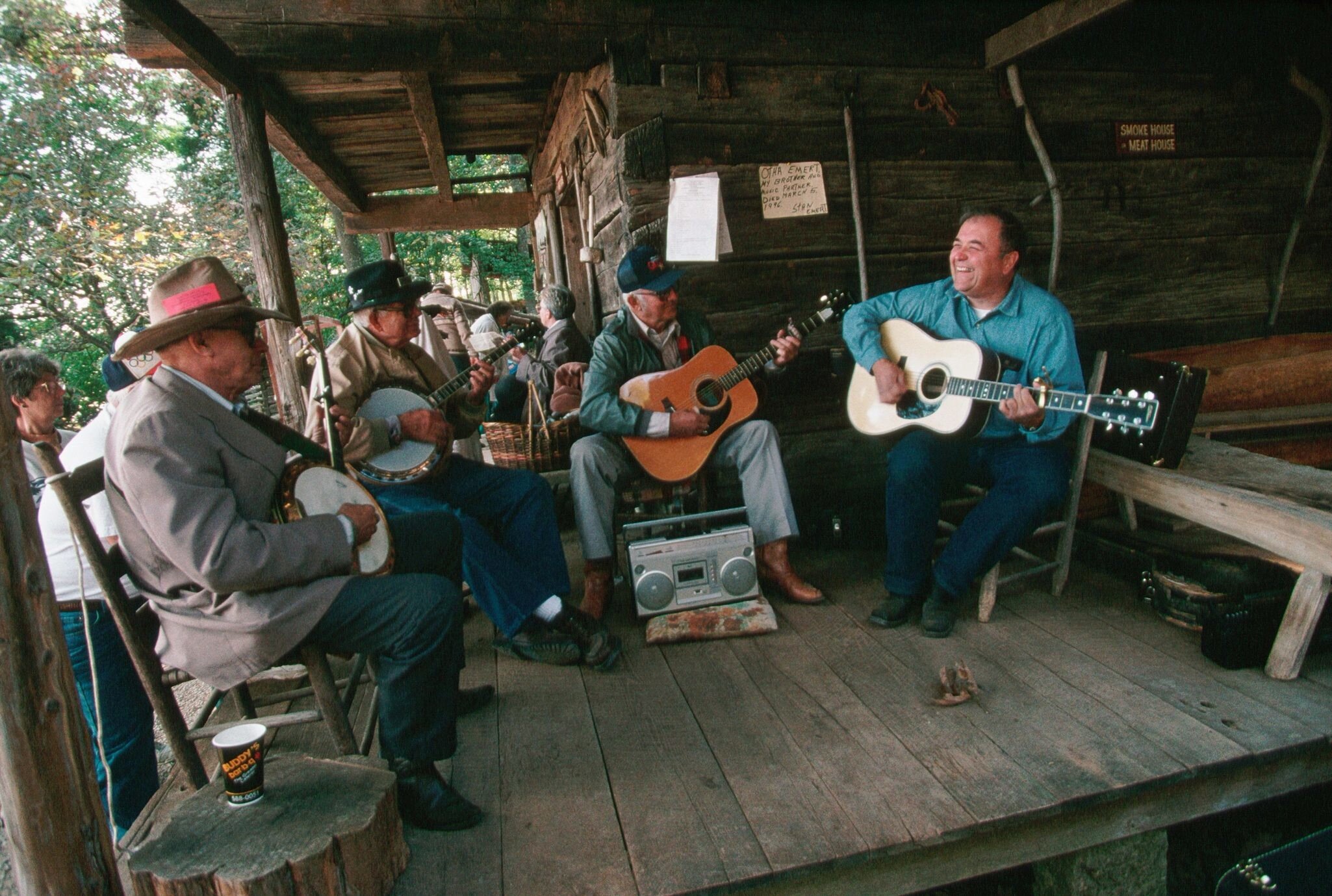 Banjoists and guitar players jam on the porch of the Museum of Appalachia during the Tennessee Fall Homecoming festival. | Location: Norris, Tennessee, USA.