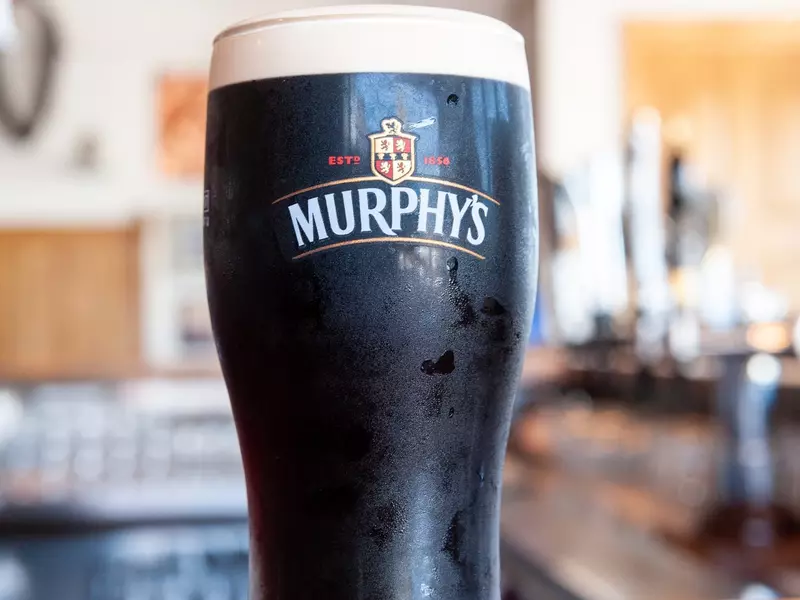 Pint glass of Murphy's stout beer served in pub. 