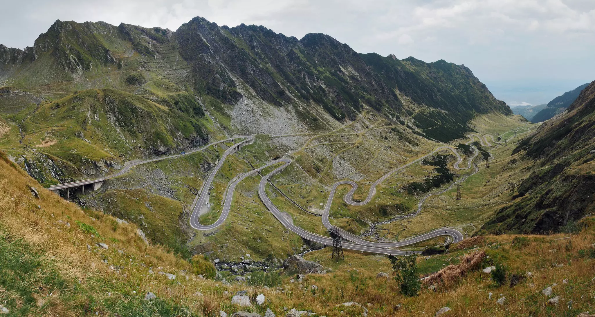 A winding mountainous road cross through the lush green hills