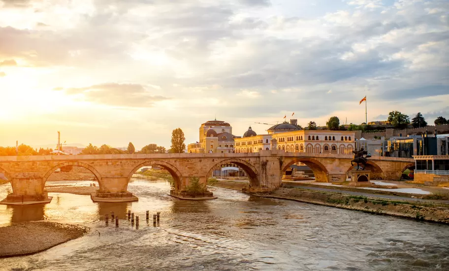 A stone bridge over the river in Skopje, North Macedonia, at sunset