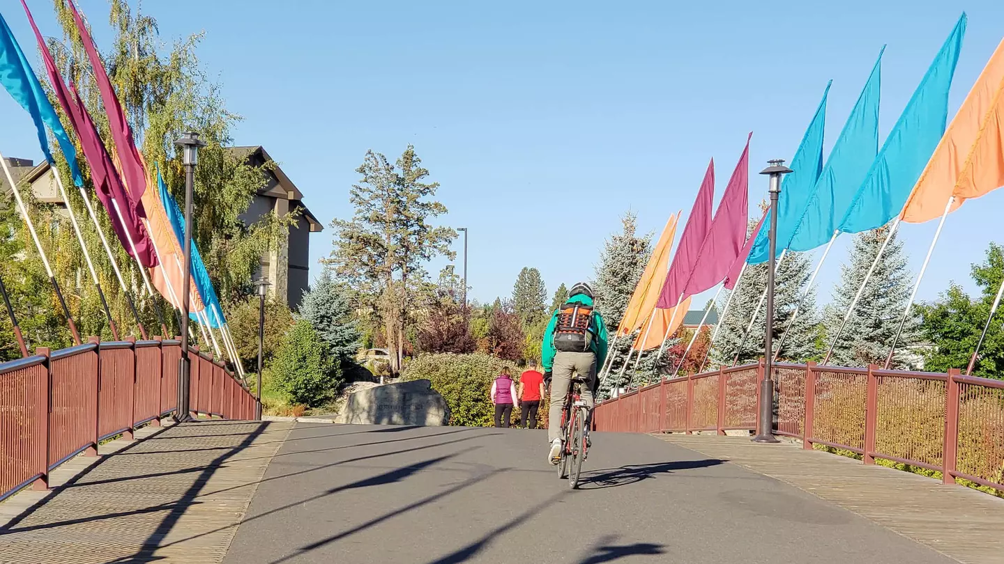 A bicyclist rides across a walking and biking bridge in Bend, Oregon