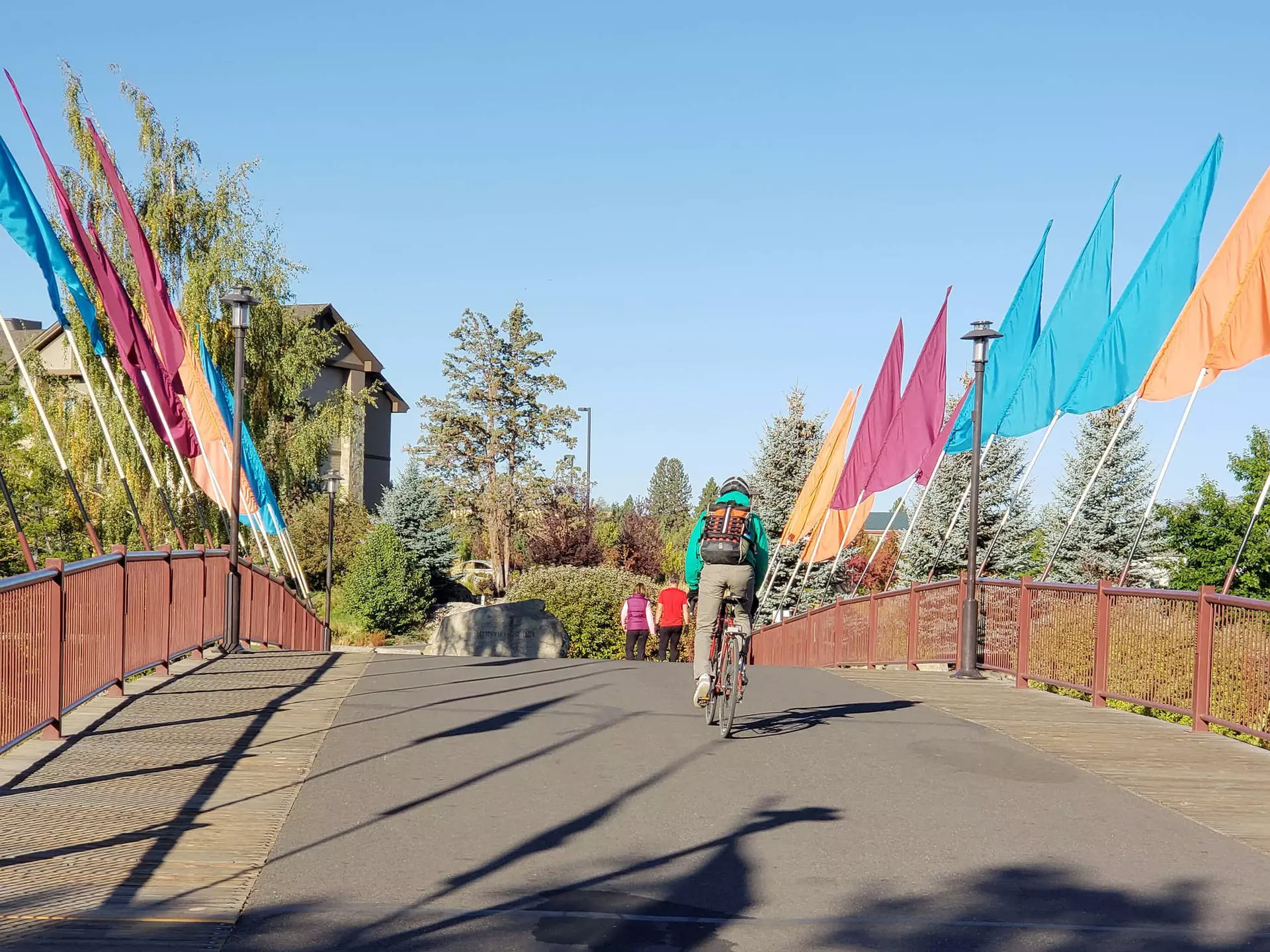 A bicyclist rides across a walking and biking bridge in Bend, Oregon