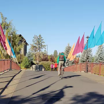 A bicyclist rides across a walking and biking bridge in Bend, Oregon