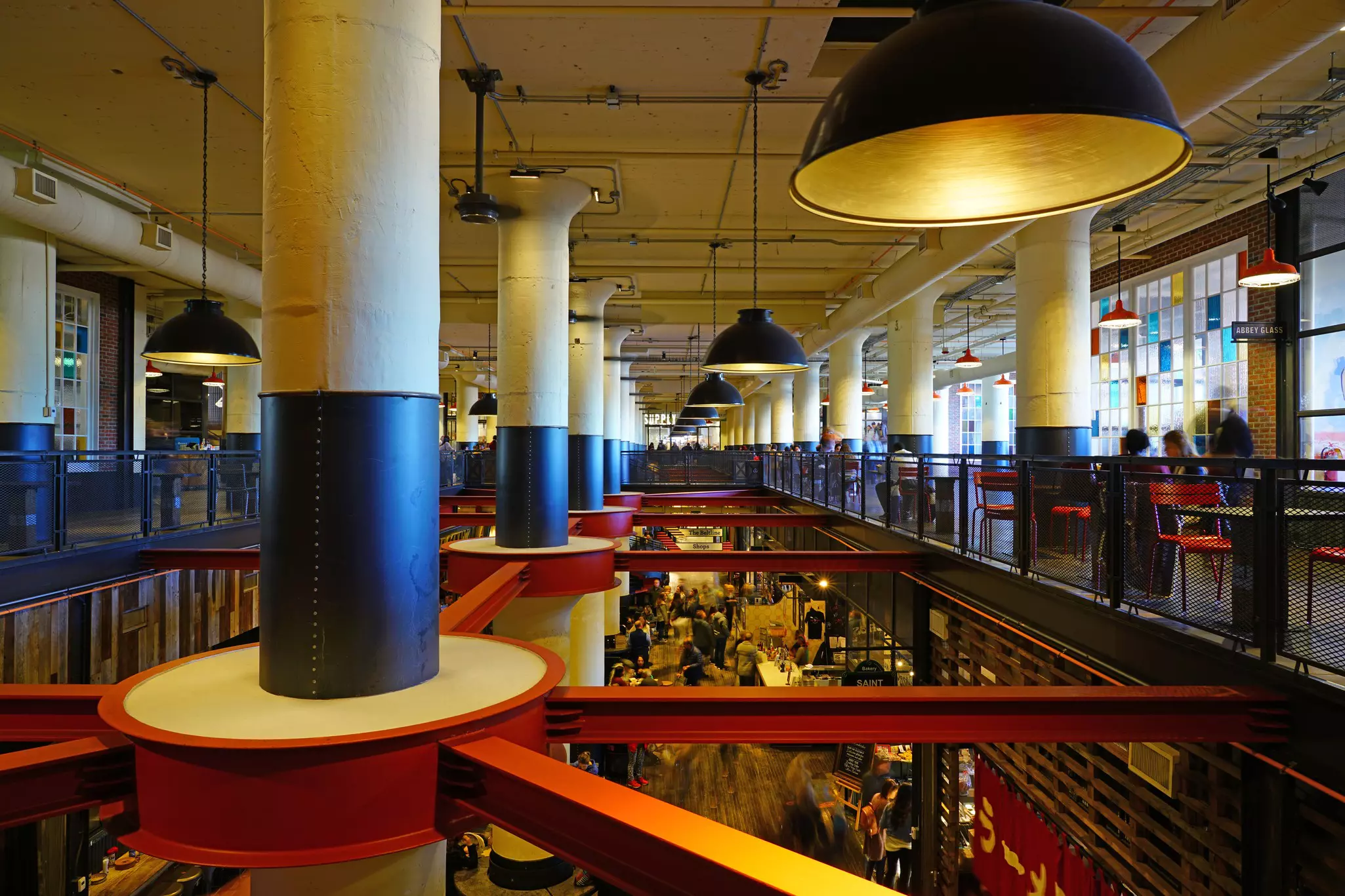 A view of beams and columns in a former factory converted into an indoor food hall and market.