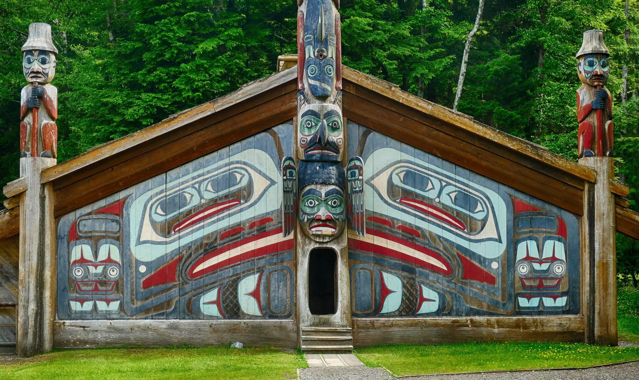 A traditional Alaska Native house with colorful totems.