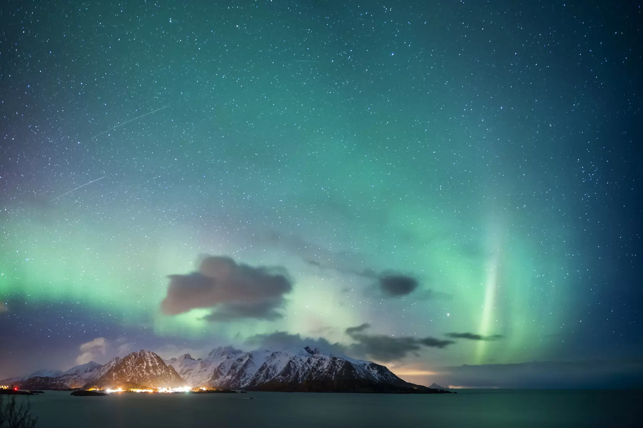 The northern lights over a snowy landscape in the north of Norway. 