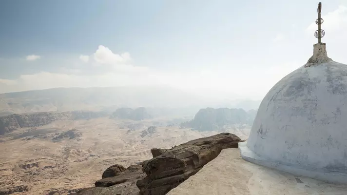 small white washed tomb over looking a vast desert landscape