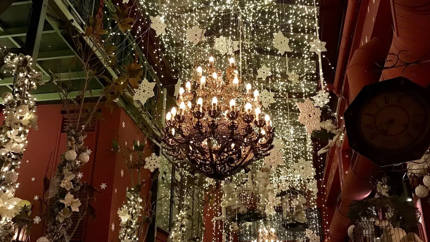 A large chandelier is covered in fake snow flakes that also hang from the ceilings at Noel Bar in Athens