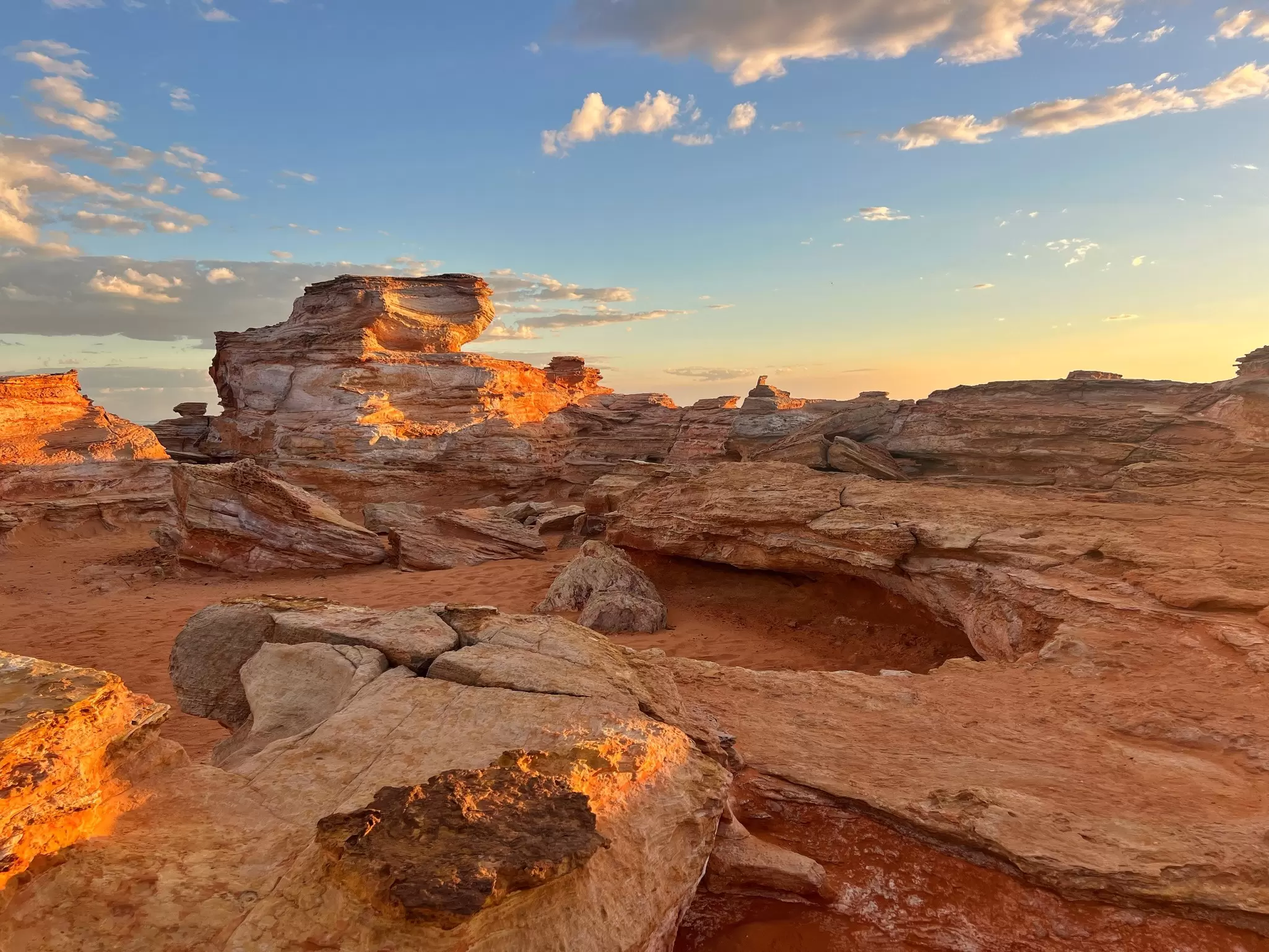 Red rocks are contrasted against a twilight sky.