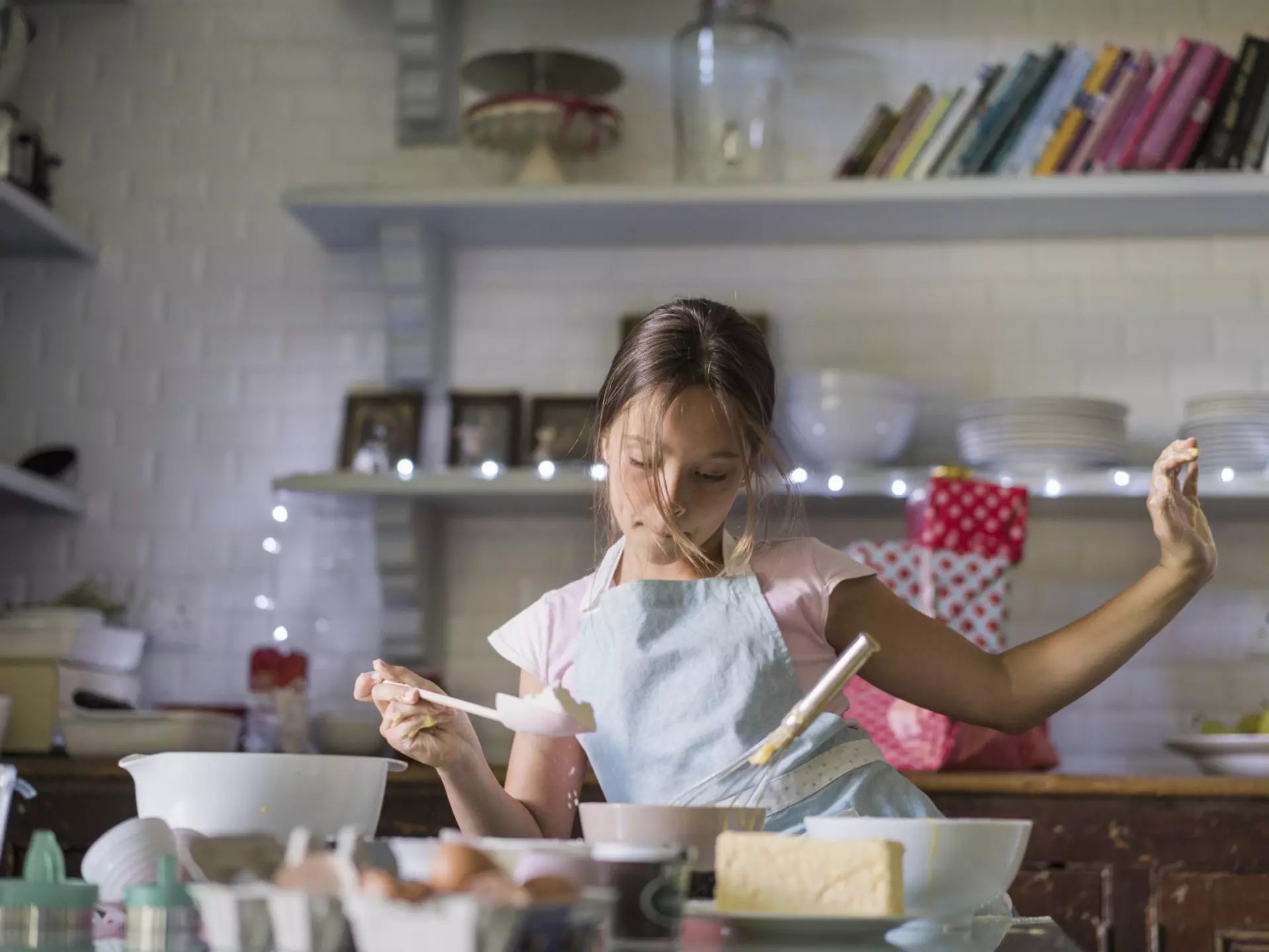 Girl is dancing while baking. Child is preparing food in kitchen. She is wearing apron.
656224593
Concentration, Leisure Activity, Lifestyles, Preparation, Childhood