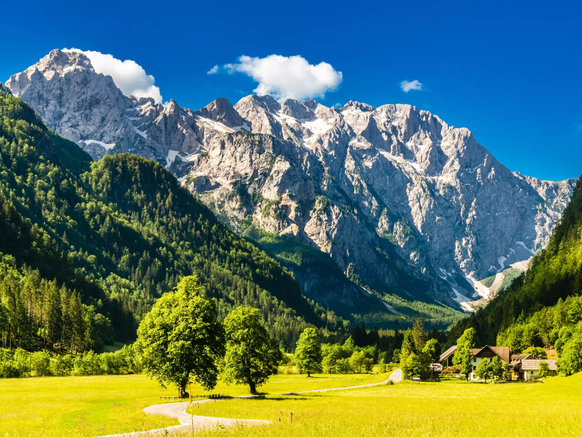Sunlight meadows and mountains in the Logar Valley