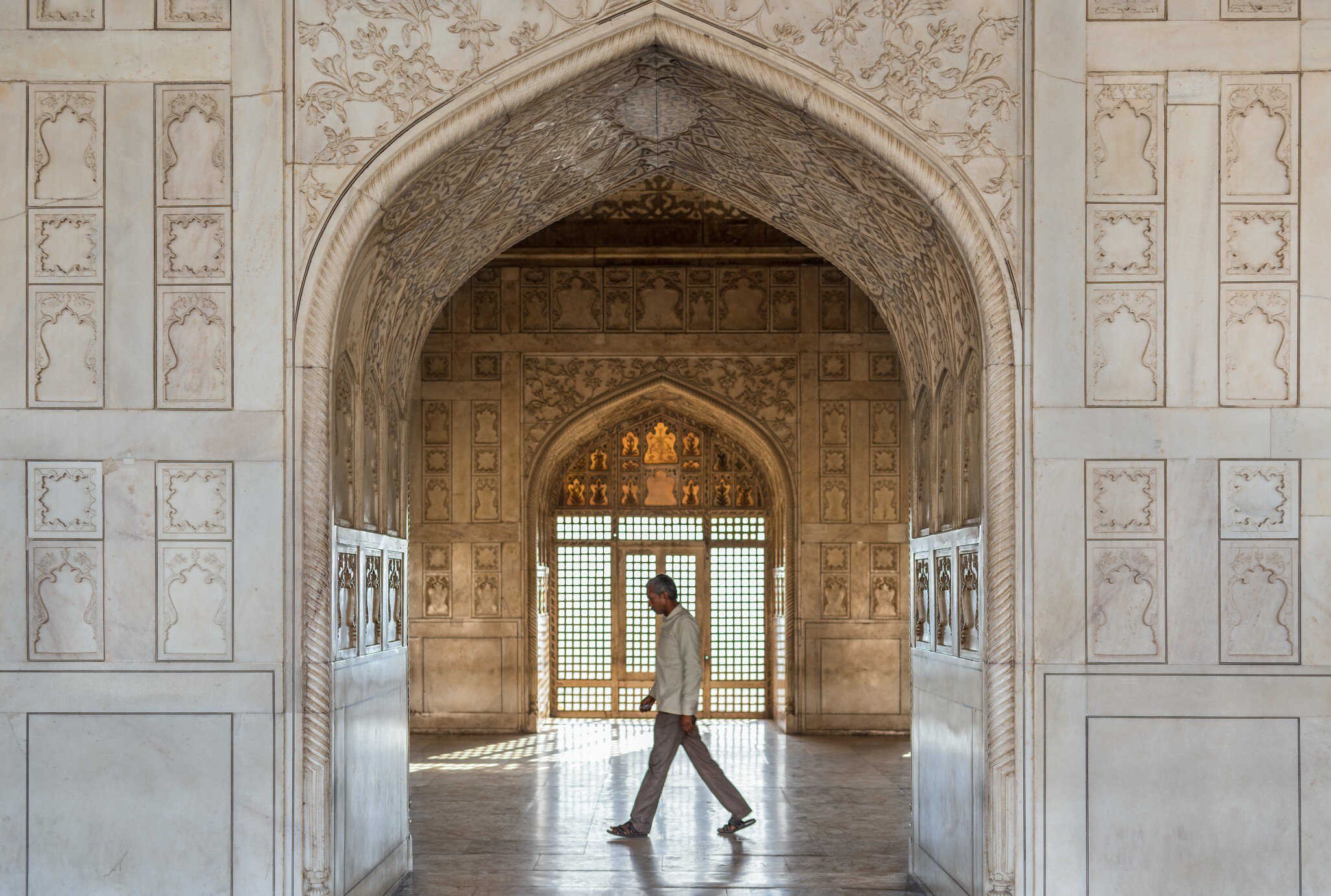 Man walks past a doorway in the Khas Mahal (Aramgah-i-Muqaddar) inside the Agra Fort.