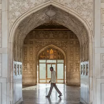 Man walks past a doorway in the Khas Mahal (Aramgah-i-Muqaddar) inside the Agra Fort.