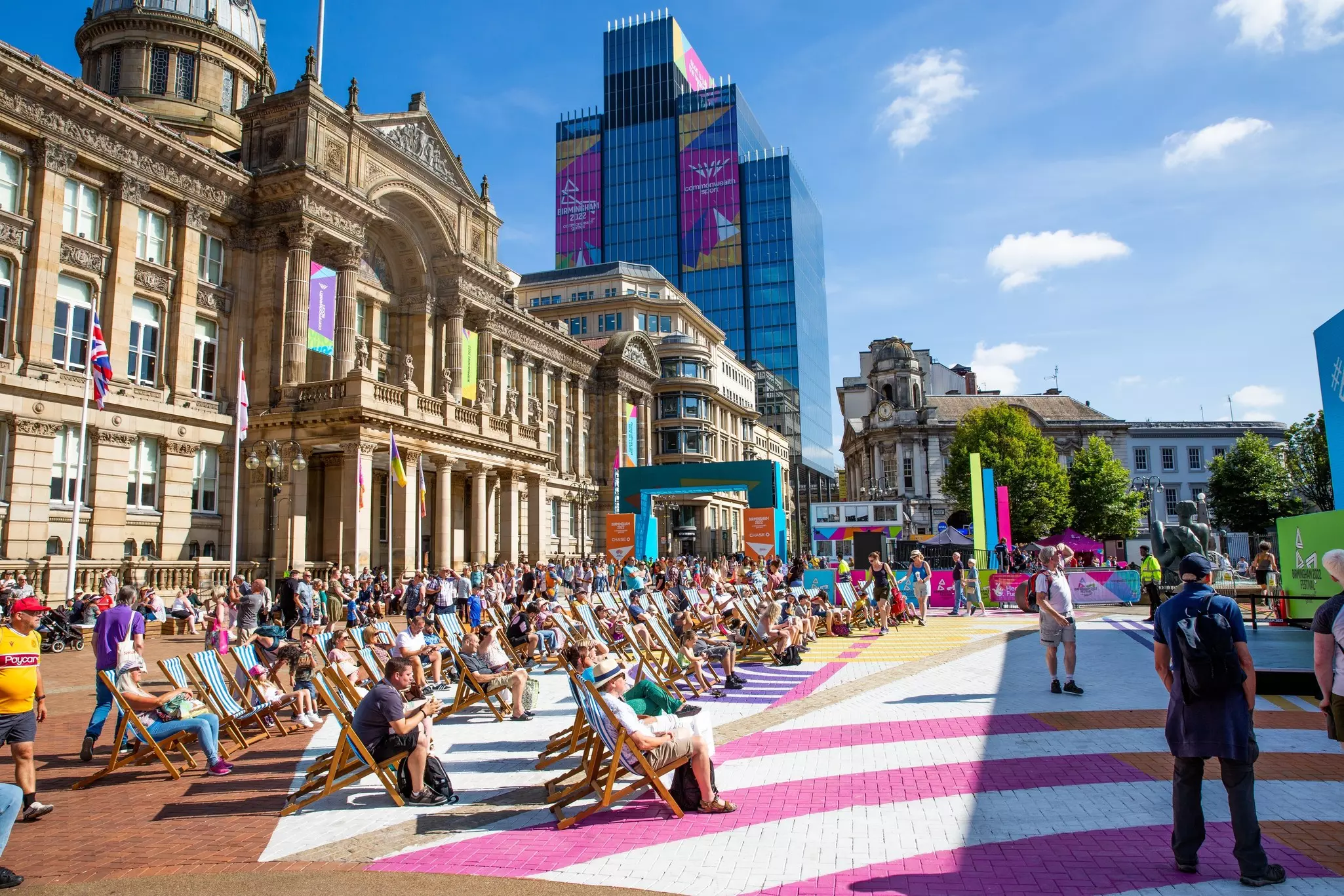 People enjoying the sunshine on deckchairs in Commonwealth Square in Birmingham. 
