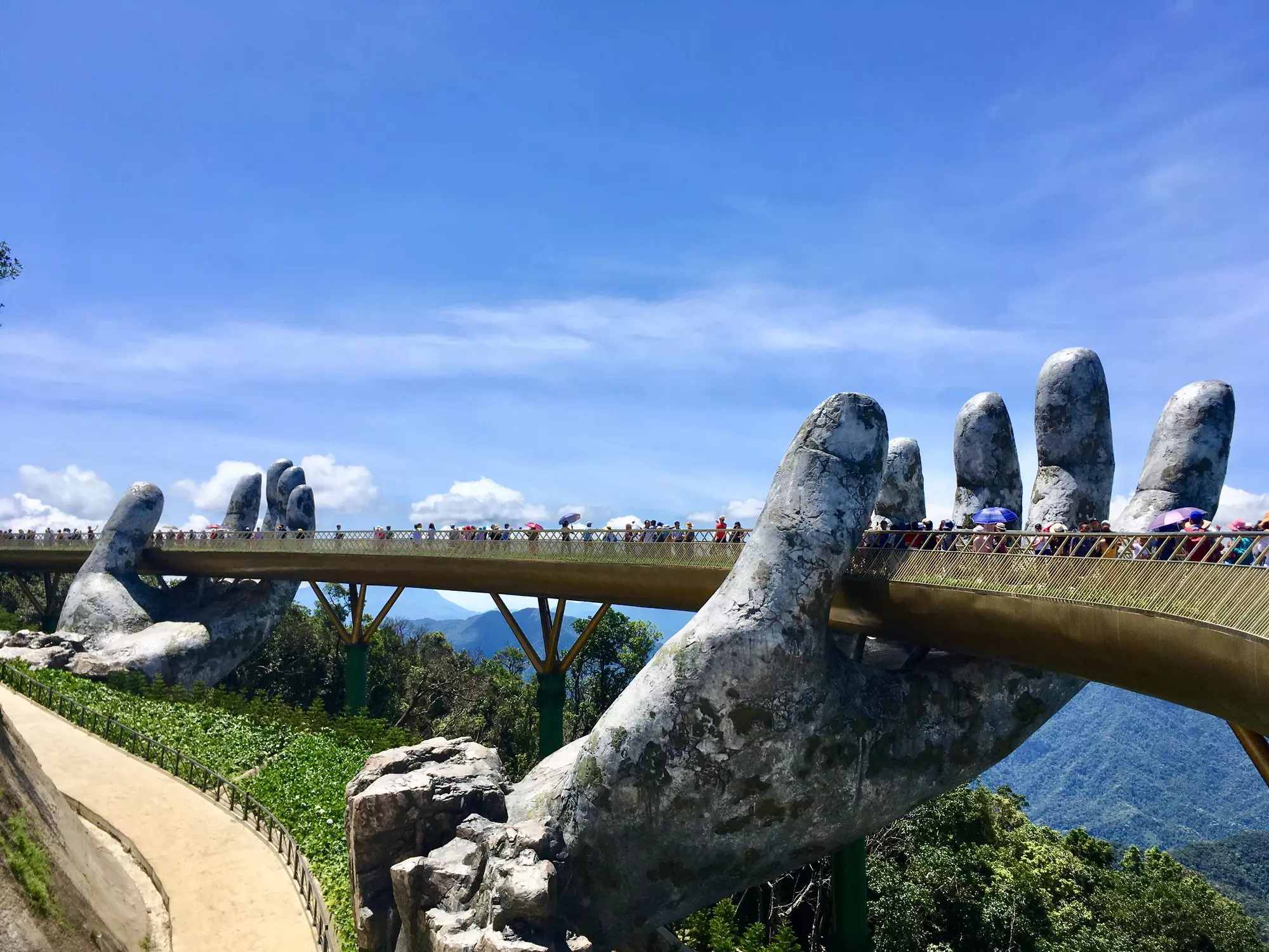 A bridge that is supported by two giant stone hands