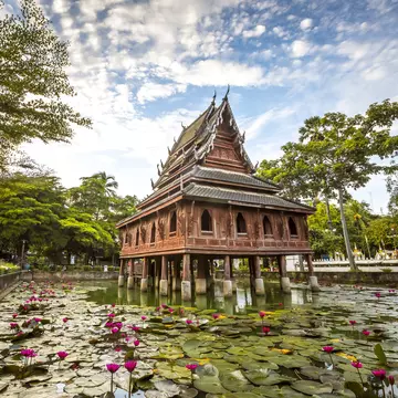 Thai wooden temple architecture on the lotus pond at wat Thung Si Muang in Ubon Ratchathani province, Thailand