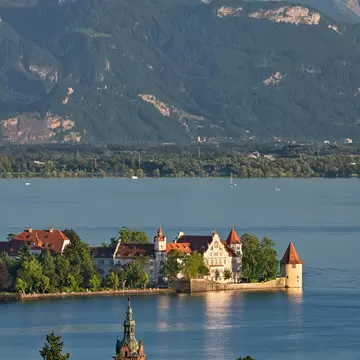 View of a red-roofed building on a lake island 