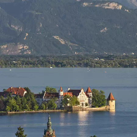 View of a red-roofed building on a lake island 