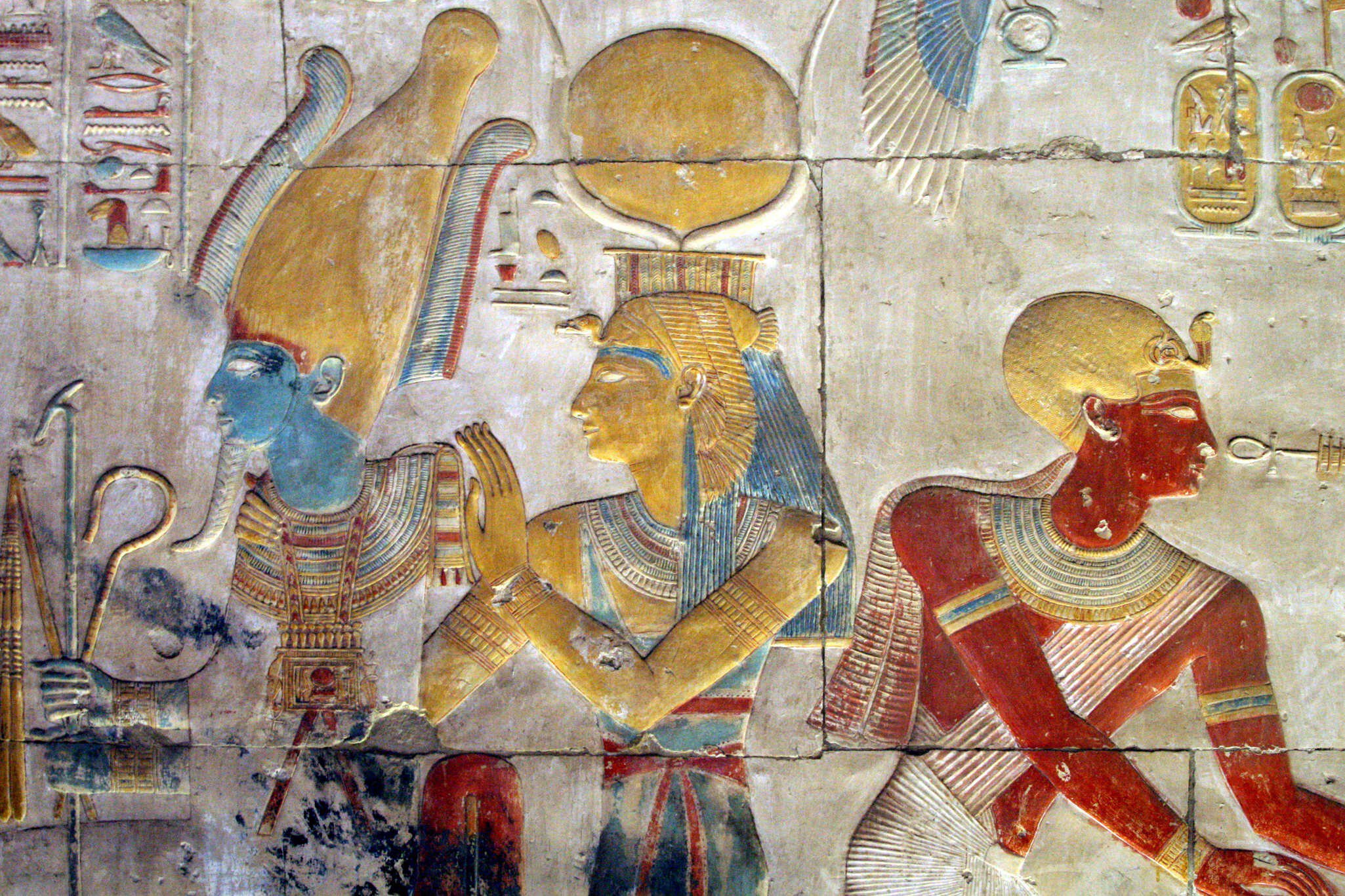Painted bas relief of Osiris and Isis wearing the headdress of Hathor at the Temple of Seti I.