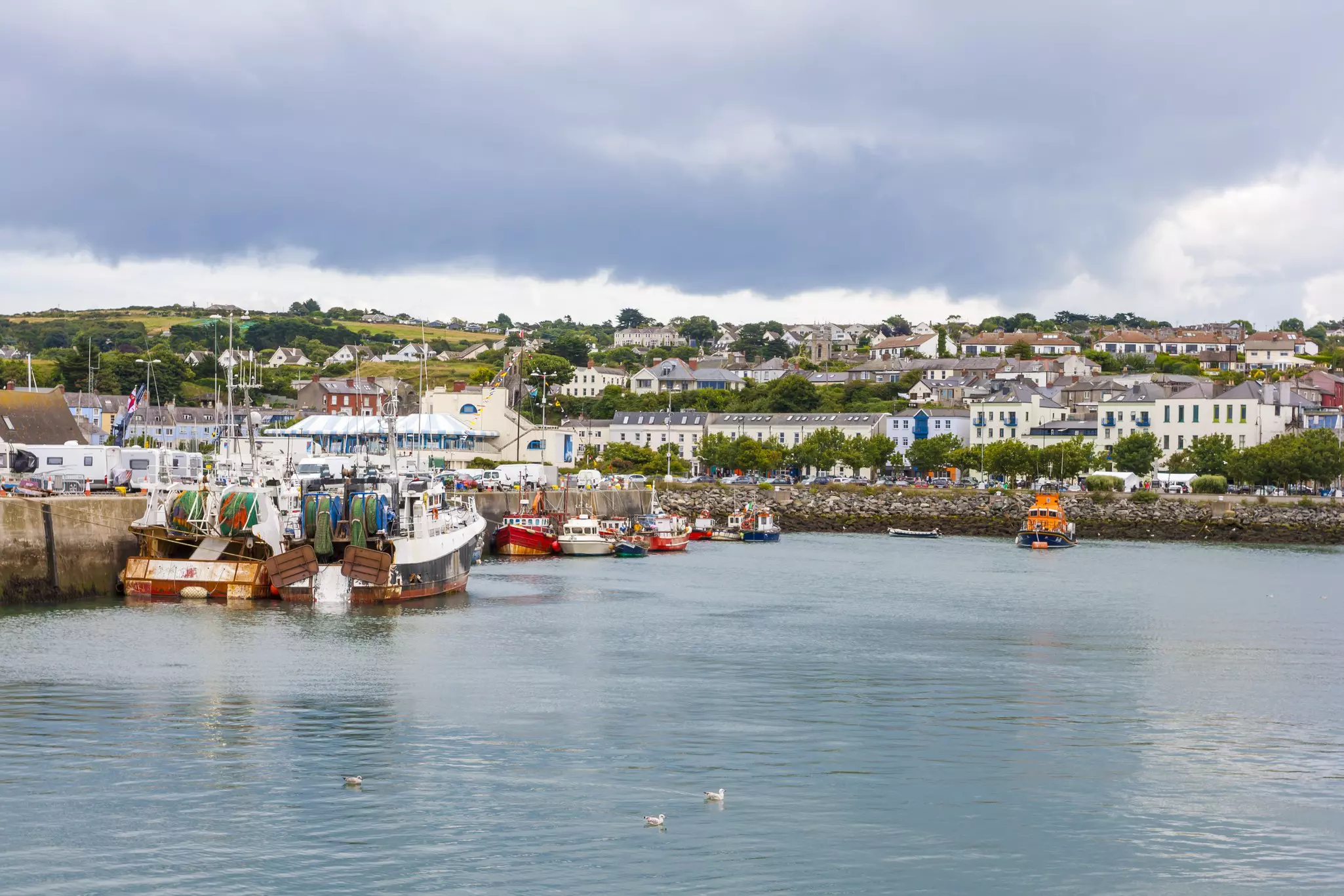 Fishing boats docked on a village harbor