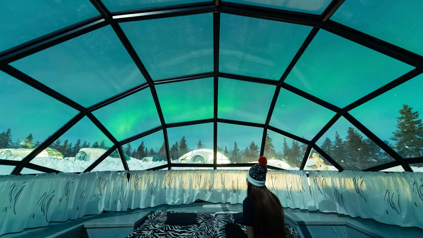 Aurora borealis shining in the night sky seen from Glass Igloos.