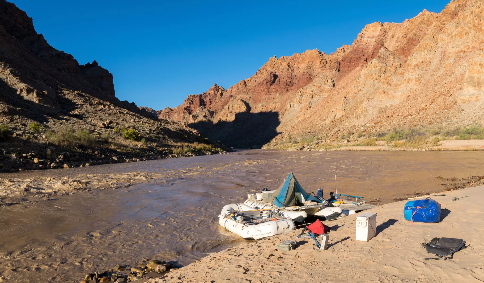 River rafts wait for passengers on the Colorado River just above the entrance to Cataract Canyon in Canyonlands National Park.
