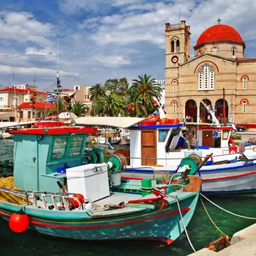 Colourful boats docked at the Port of Aegina.
174712496
sky, sea, town, quay, gulf, port, blue, boat, shore, hills, greek, yacht, front, homes, house, water, hotel, cruise, island, travel, marina, greece, summer, aegean, lagoon, window, church, aegina, europe, harbor, saronic, holiday, village, tourist, tourism, seafront, building, colorful, vacation, mountains, pictorial, landscape, varicolored, architecture, mediterranean