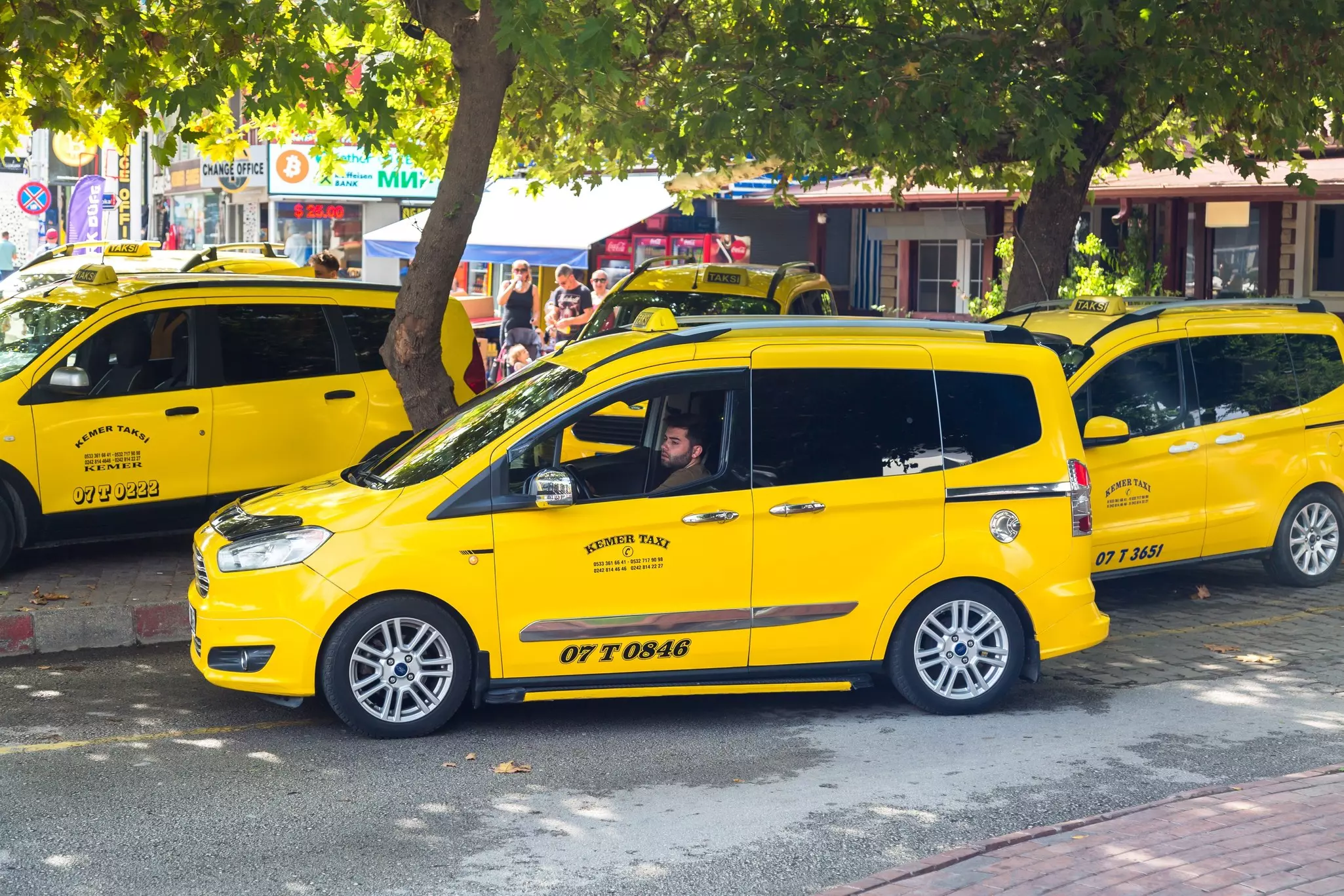 A cluster of yellow cabs waiting for passengers