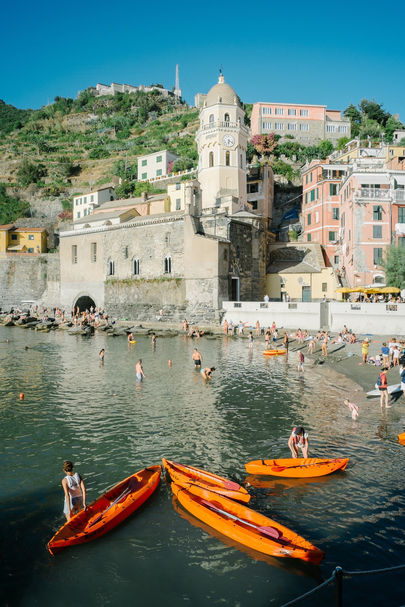People swim in the harbor of Vernazza, a tourist town in the Cinque Terre.