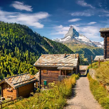 Sunny summer morning in Zermatt village with Matterhorn (Monte Cervino, Mont Cervin) peak on backgroud. Beautiful outdoor scene in  Swiss Alps, Valais canton, Switzerland, Europe.