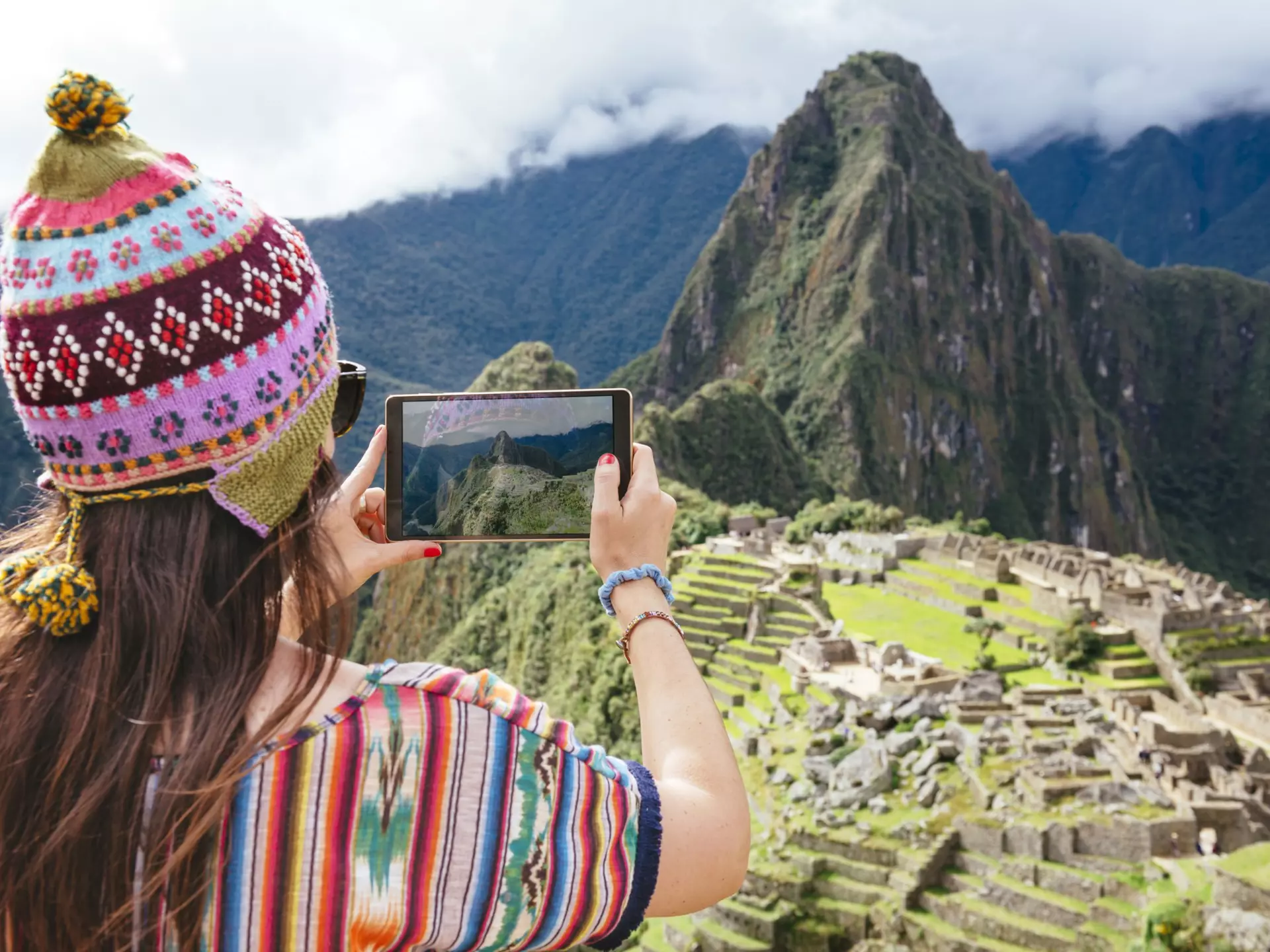 Peru, woman taking pictures of Machu Picchu citadel and Huayna Picchu mountain with a tablet
People Symbol Communication History Lifestyles Nature Technology Travel Destinations Horizontal Outdoors 30-34 Years Rear View South America Caucasian Ethnicity Tourist Old Ruin Peru Multi Colored Famous Place Cloud - Sky Mountain Mountain Range Mountain Peak Day Andes Machu Picchu Traditional Clothing One Person Inca Adult Mid Adult 30-39 Years Cusco Region Color Image Knit Hat Women Mid Adult Women One Mid Adult Woman Only Only Women One Woman Only Looking At View Photography Bobble Hat Digital Tablet Convenience Photographing Tourism Photography Themes Computer Travel Mt Huayna Picchu Vibrant Color Wireless Technology Adults Only incan empire UNESCO World Heritage Site Mini Tablet Inca Ruins