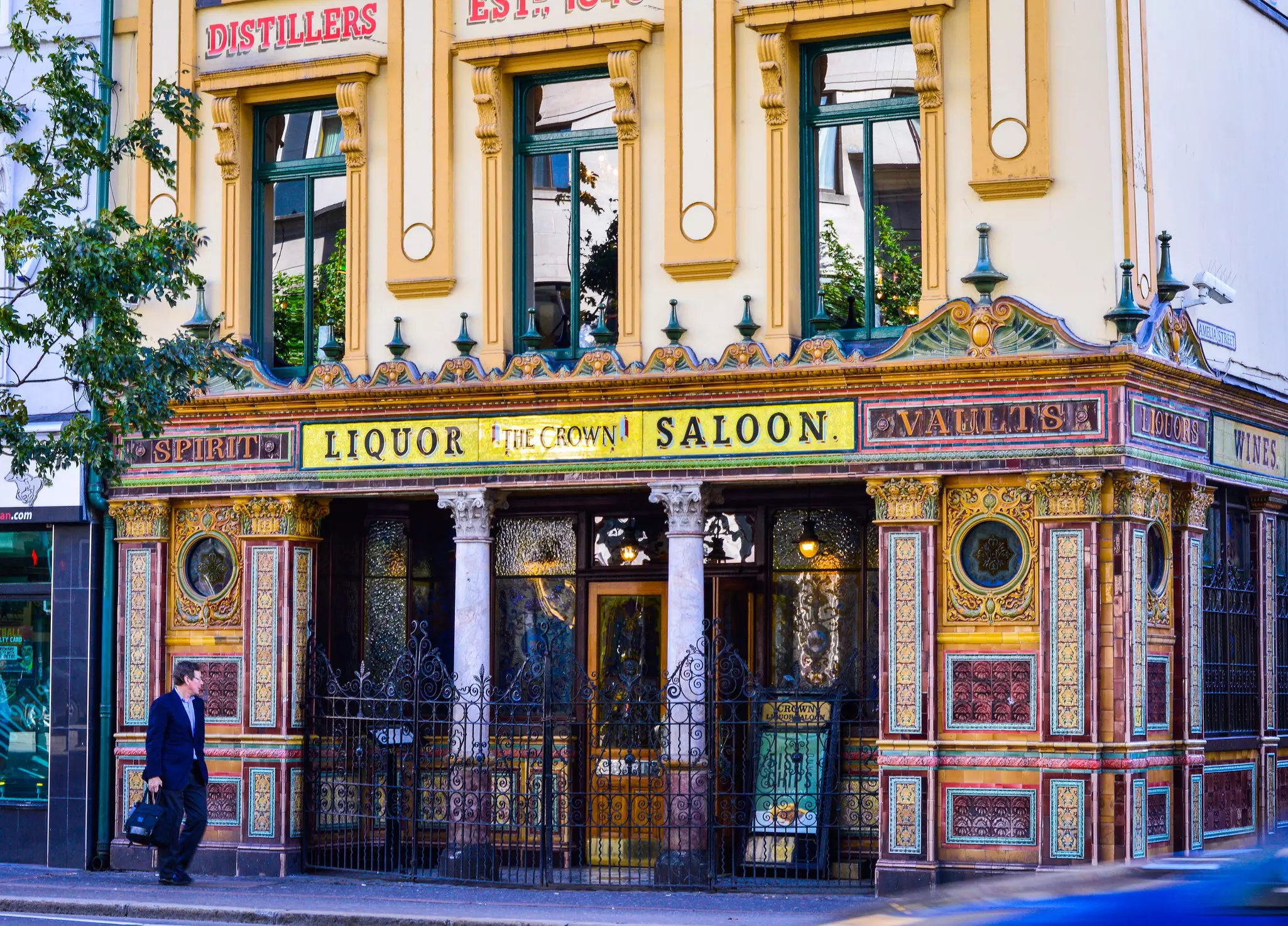 The facade of a bar in Belfast is elaborately decorated with colored tiles and mosaics.